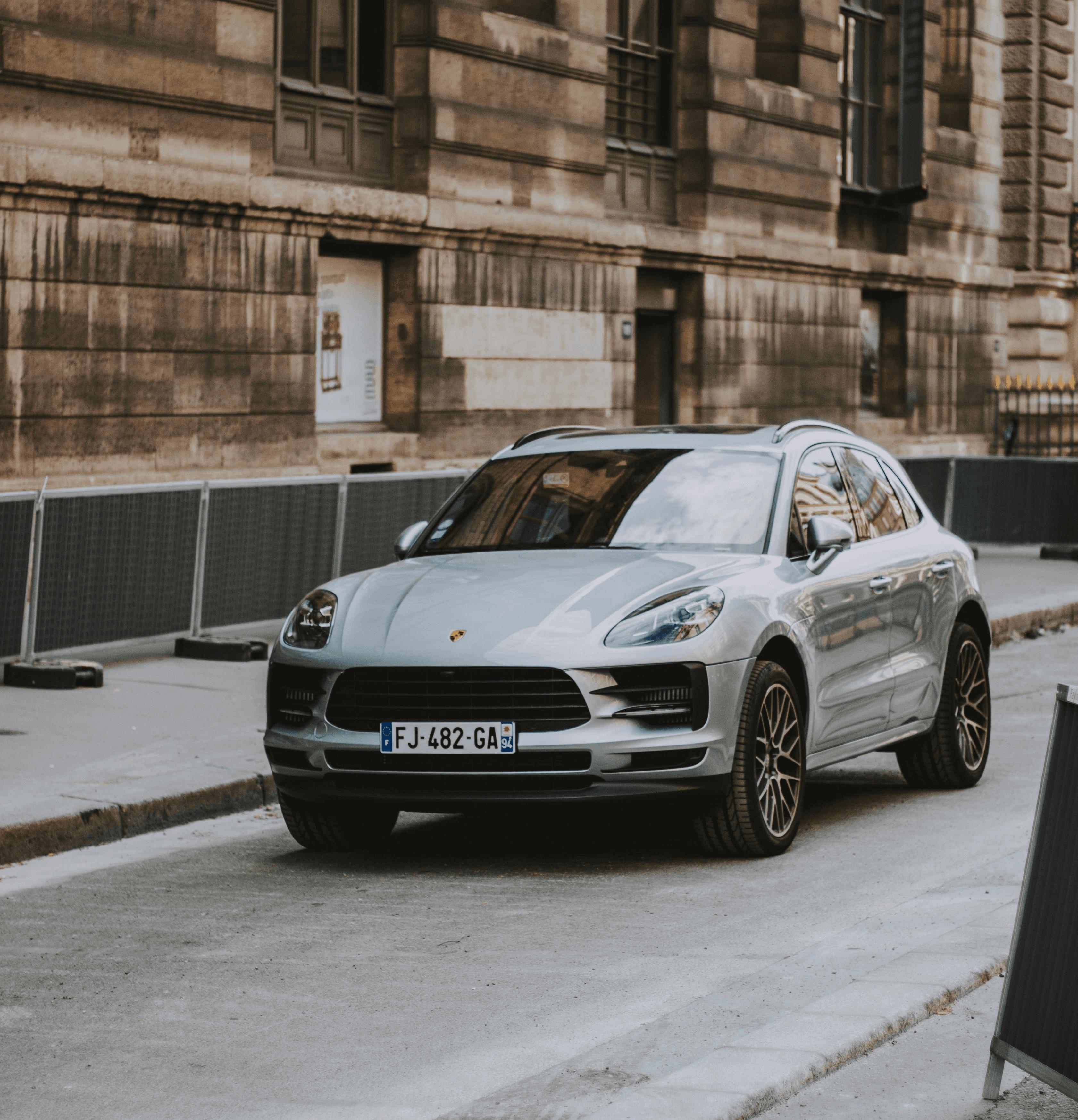 Silver luxury SUV on a city street